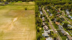 Farm Land meeting suburban neighbourhood property lines and real estate